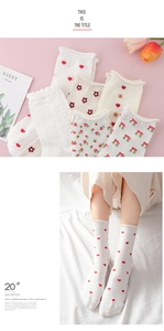 Detail of cotton crew socks featuring cute floral cherry and red heart patterns with frill edges