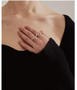 Close-up of irregular 925 silver liquid metal ring on finger with polished finish