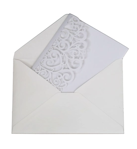 Detailed view of white pearlescent envelope with laser-cut hollow lace design wedding card