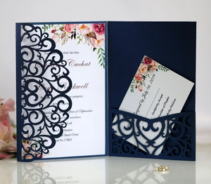 Detail of navy blue laser-cut wedding invitation set with floral cards and RSVP card