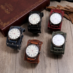 Five assorted vintage wide leather cuff watches in various colors on a rustic wood surface