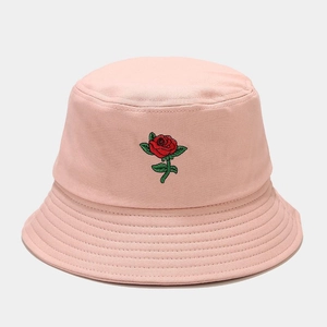 Detailed close-up of red rose embroidery on a pink cotton bucket sun hat for women