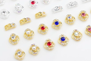 Detailed close-up of 520 metal charms with colorful rhinestones for nail art designs