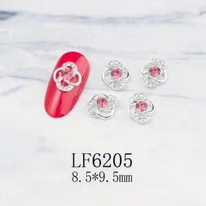 Detailed macro view of 8.5x9.5mm silver flower nail art charm with a pink gemstone