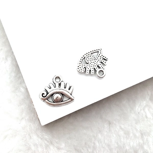 Detailed view of silver Eye of Horus alloy pendants for DIY necklace and bracelet jewelry
