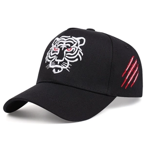 Detail of embroidered tiger head and red claw marks on a black baseball cap