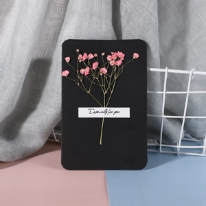 Detail of black greeting card with pink dried flowers and Especially for you text