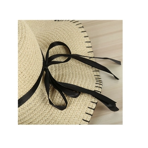 Women's woven straw sun hat with black ribbon bow and elegant pearl accent for summer