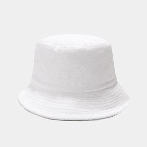 Detailed texture of white terry cloth bucket hat fabric with soft minimalist lighting