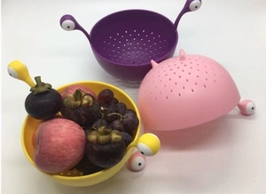 Set of three colorful monster-shaped pasta drainers with cartoon eye handles for kitchen use