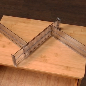 Adjustable transparent brown drawer dividers for organizing clothes and home essentials
