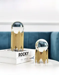 Close-up of luxury Nordic crystal ball ornaments with gold metal bases on marble
