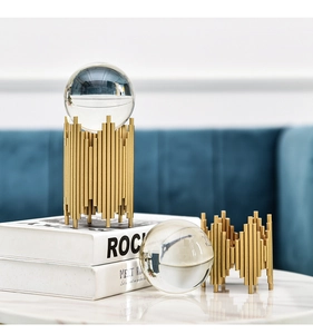 Macro detail of modern crystal ball ornament with gold columnar metal base for home decor