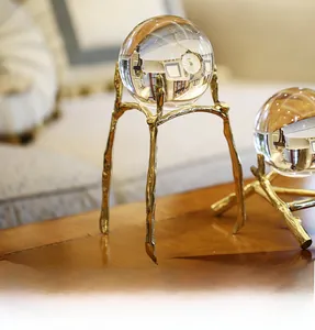 Detail of clear crystal spheres on golden branch-shaped metal stands for home decor