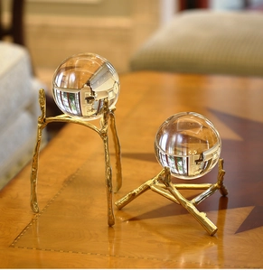 Detailed view of luxury crystal balls on golden textured metal branch bases