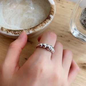Detailed view of silver bubble ring with smooth spherical spheres on a woman's hand