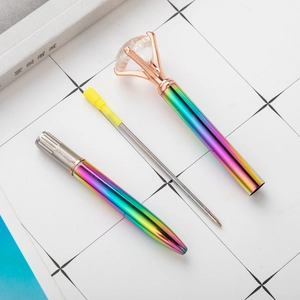 Rainbow gradient metal diamond pen featuring rose gold accents and a large crystal top