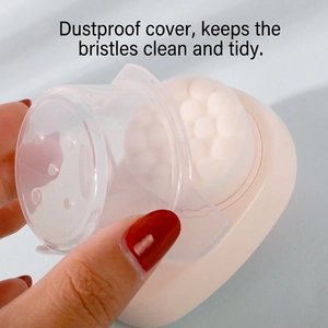 Dual-sided silicone facial cleansing brush with white bristles and transparent dust cover