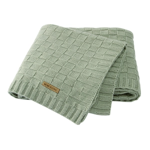 Light green knitted baby blanket with square weave texture and leather brand label
