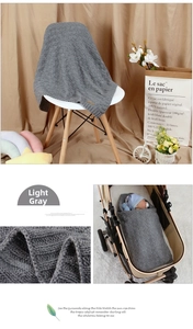 Macro shot of light gray diamond knit baby blanket fabric with leather patch detail