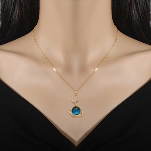 Elegant gold titanium steel necklace featuring a blue planet pendant with a crystal butterfly