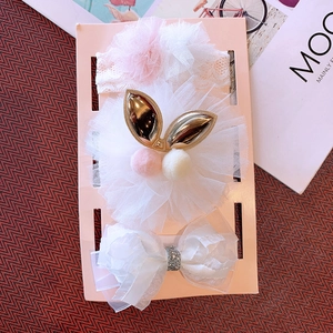 Detailed set of baby floral lace headband and hair accessories on a pink display card
