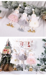 Detailed view of pink and white plush angel ornaments with bell accents and knit details