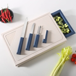Kitchen wheat straw cutting board set with knives and peeler on a clean countertop