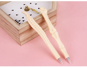 Two bone-shaped ballpoint pens featuring spinal and limb bone designs on a pink background