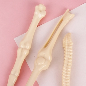 Novelty bone-shaped ballpoint pens for students featuring realistic skeleton designs