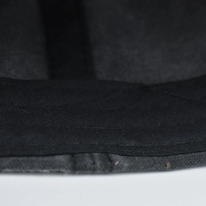 Detailed macro view of the inner sweatband and stitching on this black washed baseball cap