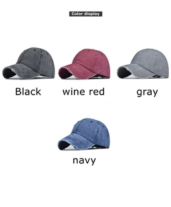 Close-up of distressed washed denim baseball caps in black, wine red, gray, and navy colors