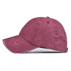 Close-up of washed cotton baseball cap with distressed details and vintage finish