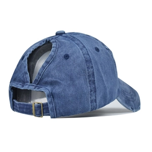 Detail of washed denim ponytail baseball cap featuring adjustable metal buckle at back