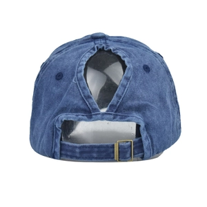 Detail of washed blue ponytail baseball cap showing the hair opening and metal buckle