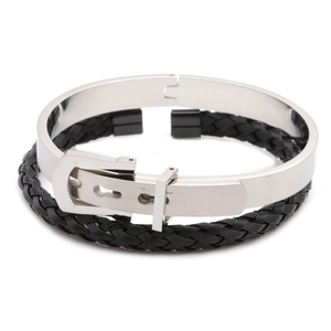 Detail of silver stainless steel cuff bracelet and black braided rope wristband for men