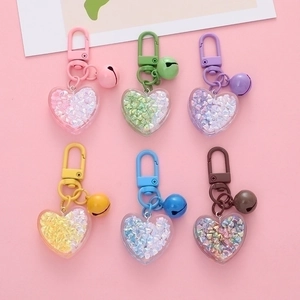 Colorful acrylic heart-shaped keychains with origami stars and small bells set of 6