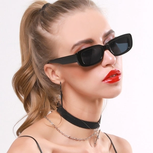 Close-up of black rectangular sunglasses on a female model with a silver necklace