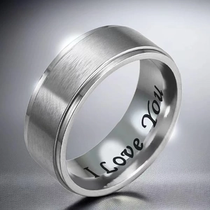 Detailed shot of brushed silver titanium ring with I Love You engraved inside