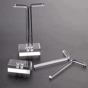 Macro detail of clear acrylic L-shaped earring stand and base with high transparency