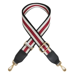 Adjustable wide shoulder strap with red, white and black stripes and gold metal hooks