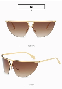 Detail of rimless Y2K tech sunglasses with gold metal frame and gradient brown lenses