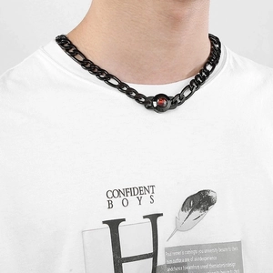 Detail of titanium steel NK chain necklace with red gemstone crystal on male model