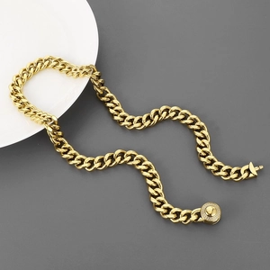 Gold-plated Cuban link chain for men with round CNC diamond-set buckle on grey background