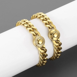 Detail view of gold-plated 11mm Cuban link necklaces with diamond and polished buckles