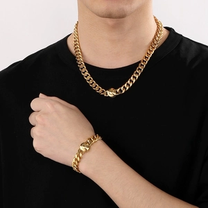 Detailed view of men's gold plated Cuban link necklace and bracelet set with magnetic clasps