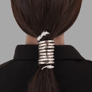 Detailed view of silver snake-shaped metal hair coils wrapped around a ponytail
