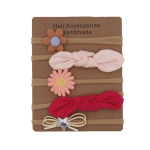 Detail of 5-piece floral bow baby headband set displayed on craft card packaging