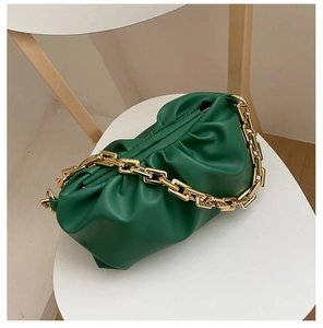 Detail of green cloud bag with soft pleats and chunky gold metal chain strap