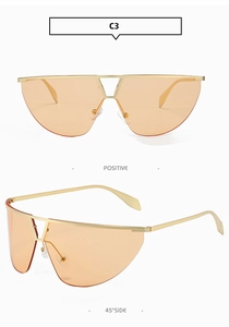 Detail view of orange frameless tech sunglasses with minimalist gold metal frame and nose pads